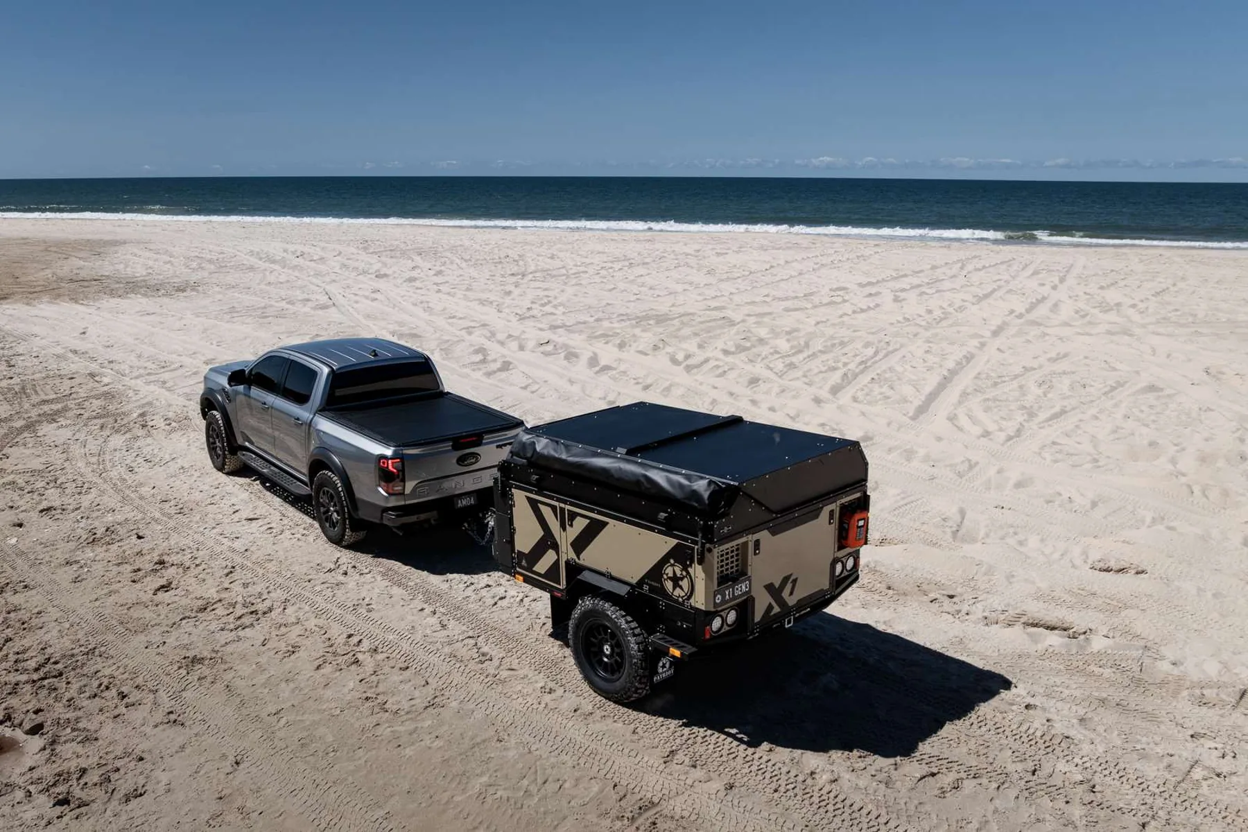 Gen3 X1 in Desert hitched to a Ford Raptor on the beach