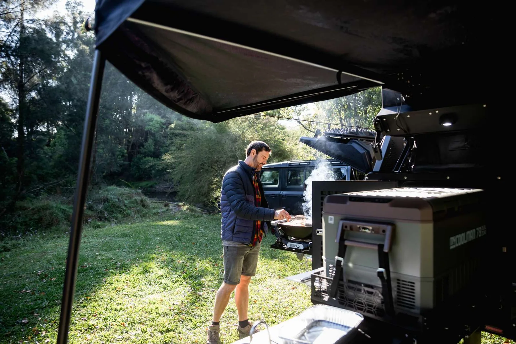 Family using the Gen3 X1 outdoor kitchen at a bush campsite