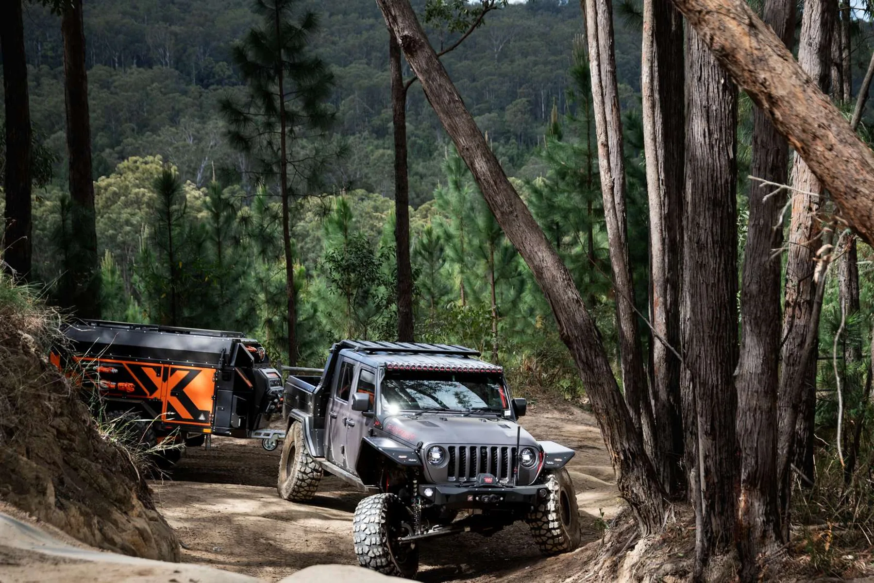 Jeep towing the Wildfire Gen3 X1 through a rocky forest track
