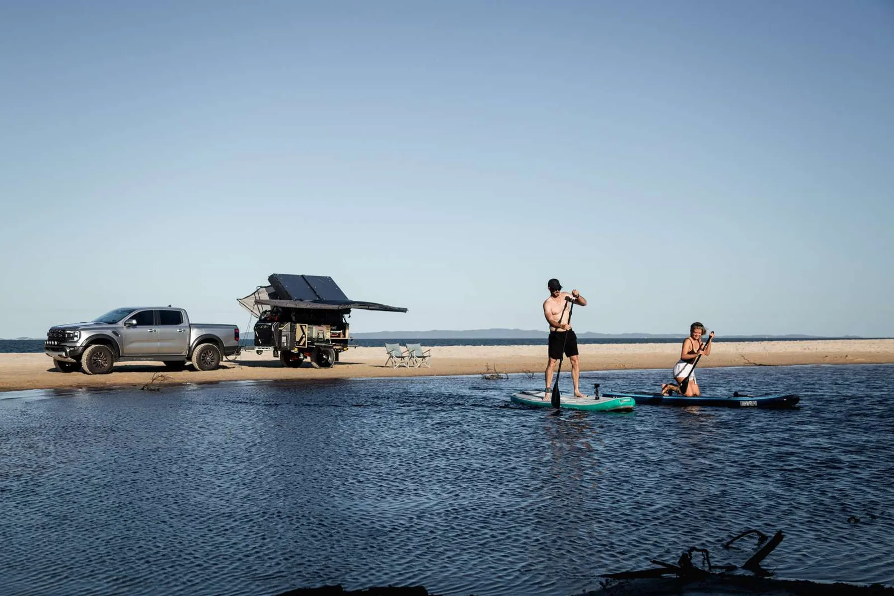 Paddleboarding beside the beach campsite
